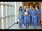 group of medical students walking down a hallway